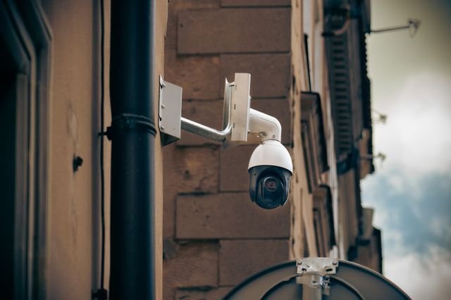 A security camera mounted on a building wall.