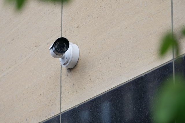 A security camera mounted on a building wall.