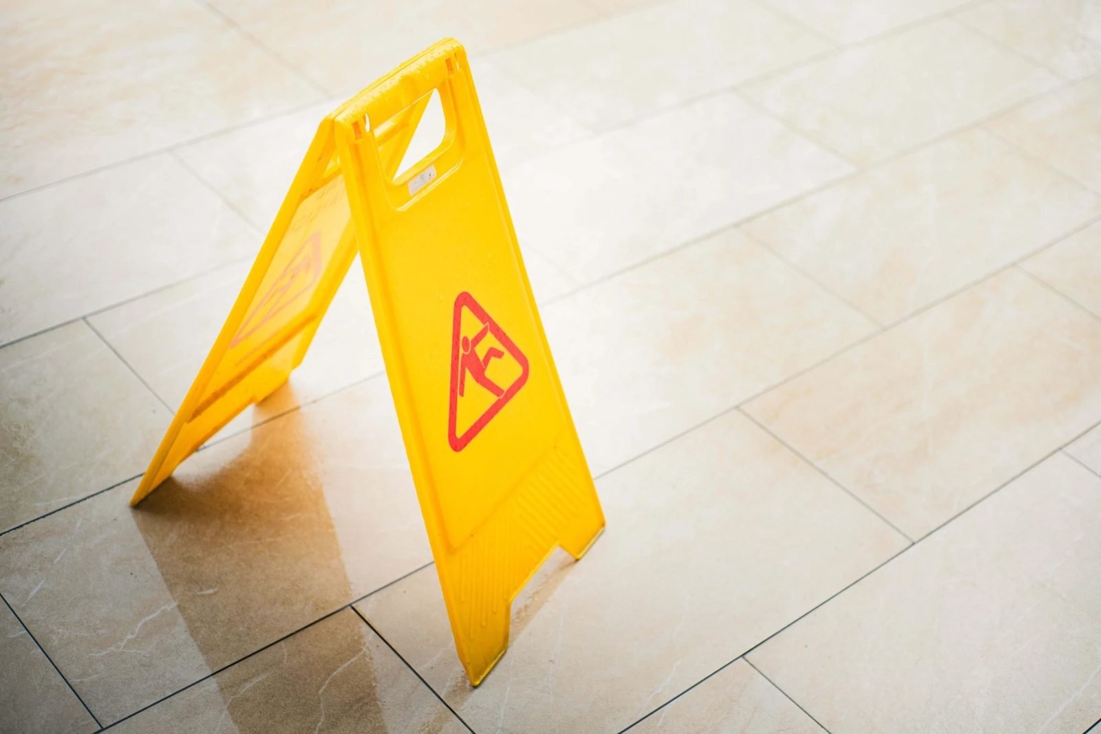 A wet-floor caution sign standing in a store aisle.